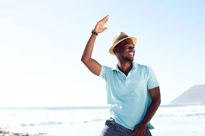 Handsome man waving one hand in the air. 