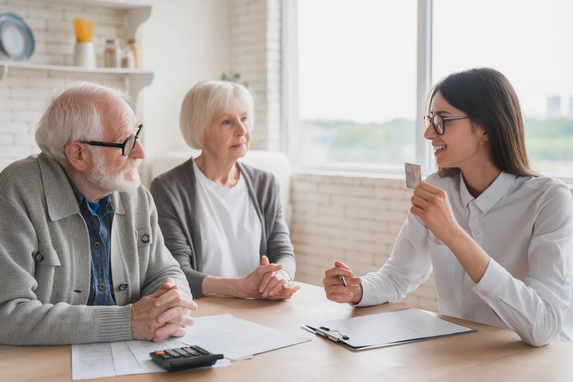 Agent discussing frequently asked questions with seniors