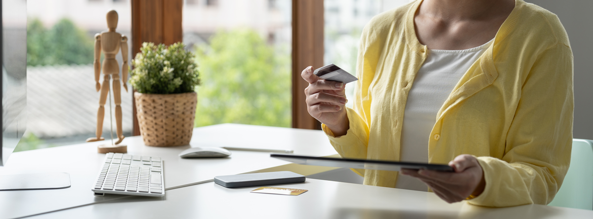 A consumer reviewing official First Financial credit card offers on a digital device, highlighting our secure and trusted application process since 1995.